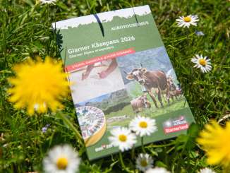 The 2026 Glarus Cheese Passport, a stamp book lying in nature