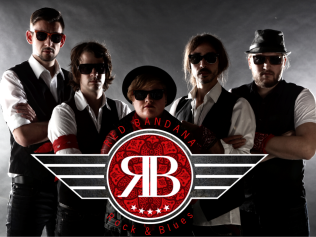 Picture of the Red Bandanas, a rock & blues band, in dim lighting, serious faces and sunglasses on with their Logo in front of them.