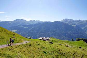The Oberblegi Alpine Pasture in Braunwald, its green surroundings, and the panoramic view