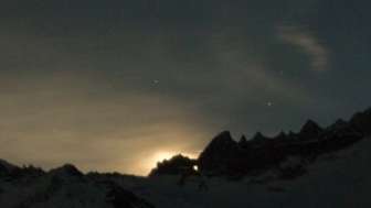 The moon shining through the Martinsloch